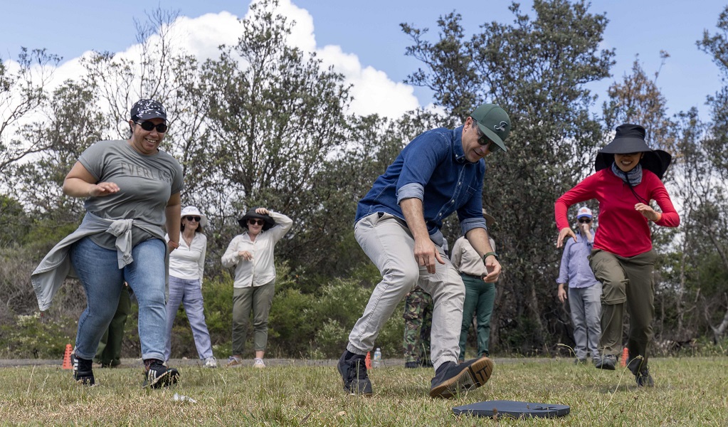 A group of corporate volunteers have fun taking part in a team-building game at Middle Head, Sydney Harbour National Park. Credit: Peter Taseski/DCCEEW &copy; DCCEEW