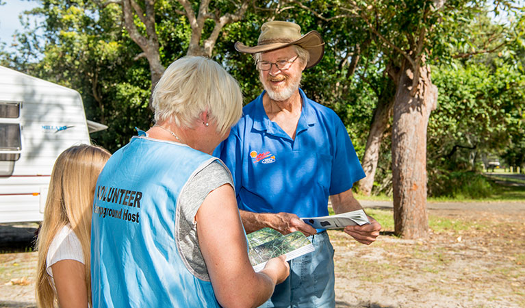 A volunteer campground host talks to visitors at Mungo Brush, Myall Lakes National Park. Photo: John Spencer/DPE &copy; DPE